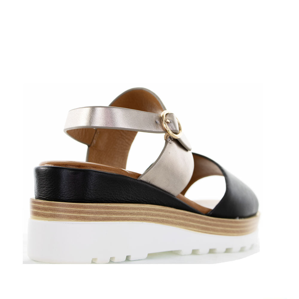 Black leather sandals from Le Sansa Sansa Tess collection featuring open toe design and ankle strap.