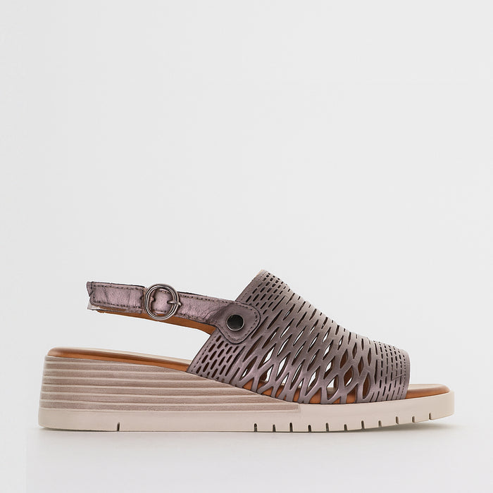 Le Sansa Sansa Topaz Pewter sandals with open toe design and metallic finish, featuring ankle straps and comfortable flat soles.