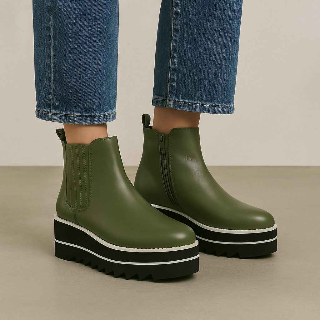 Le Sansa Trinity Olive boots with a sleek design, featuring olive green color and stylish ankle-high silhouette.