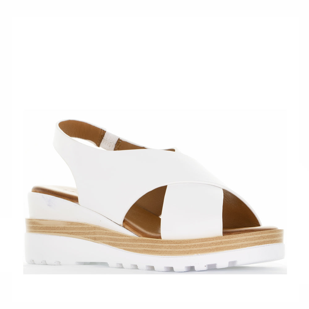 Le Sansa Trisha White sandals with open toe design and ankle strap, featuring sleek white leather for casual and summer wear.
