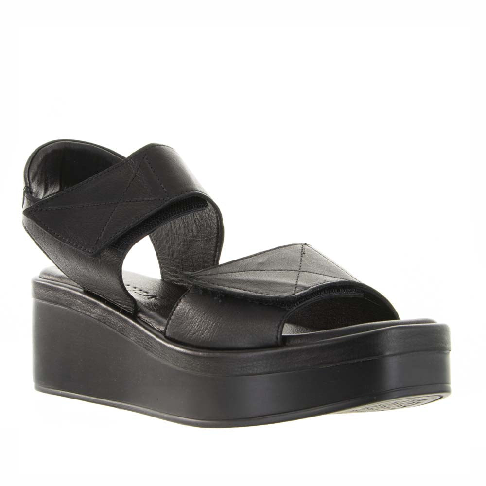 Le Sansa Tristen black sandals showing open-toe design with ankle straps and stylish buckle details.