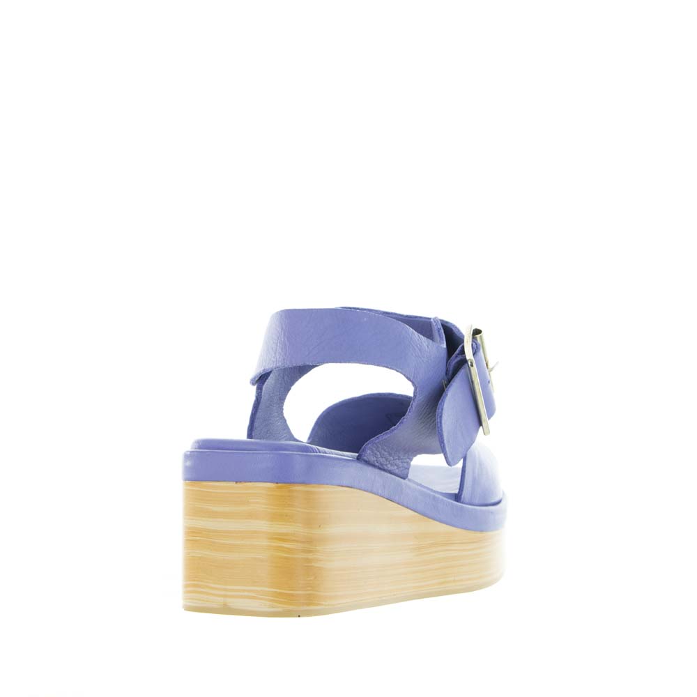Le Sansa True Purple sandals featuring open-toe design, ankle straps, and stylish purple leather material.