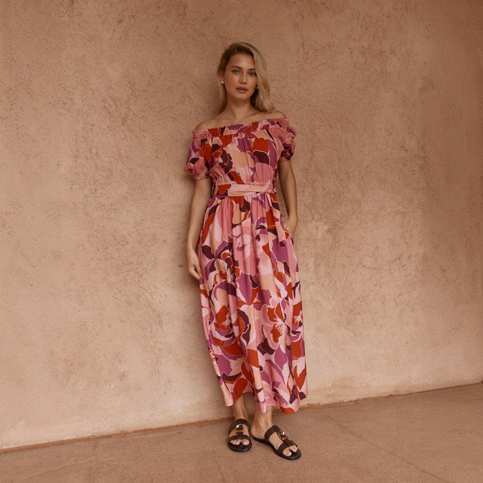 Pink off-shoulder dress with peony print from Sass Clothing, featuring a stylish and feminine design for casual or special occasions.