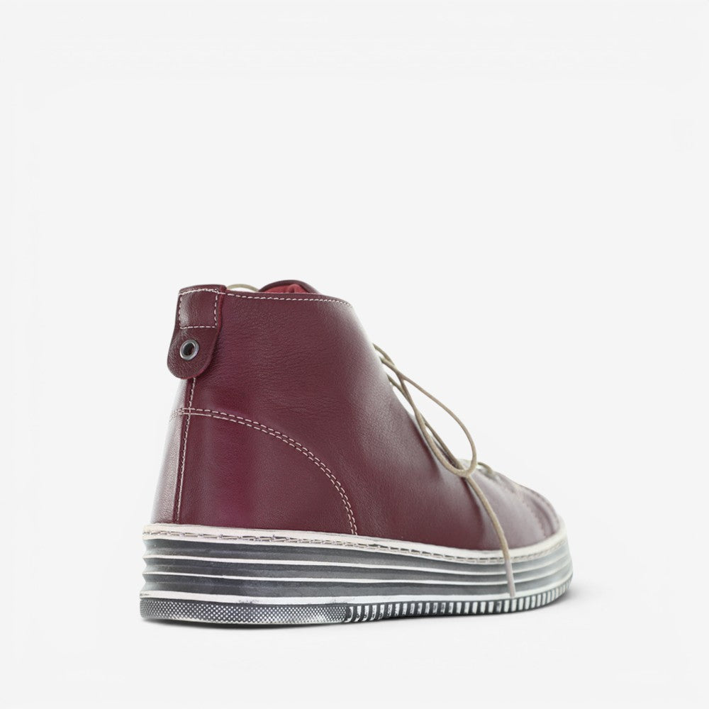 LE SANSA Vivid Red boots with sleek design and vibrant red color, featuring a stylish silhouette and detailed stitching.