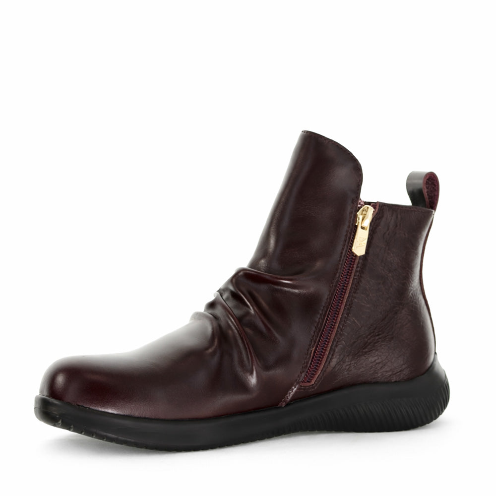 Naked Arches Yila Wine boots featuring a sleek design with a wine-colored leather finish and stylish ankle height.