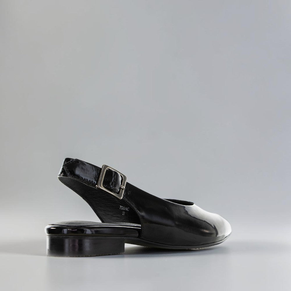 NAKED ARCHES Zodiac Black Patent sandals with sleek black patent straps and Zodiac-themed embellishments on the footbed.