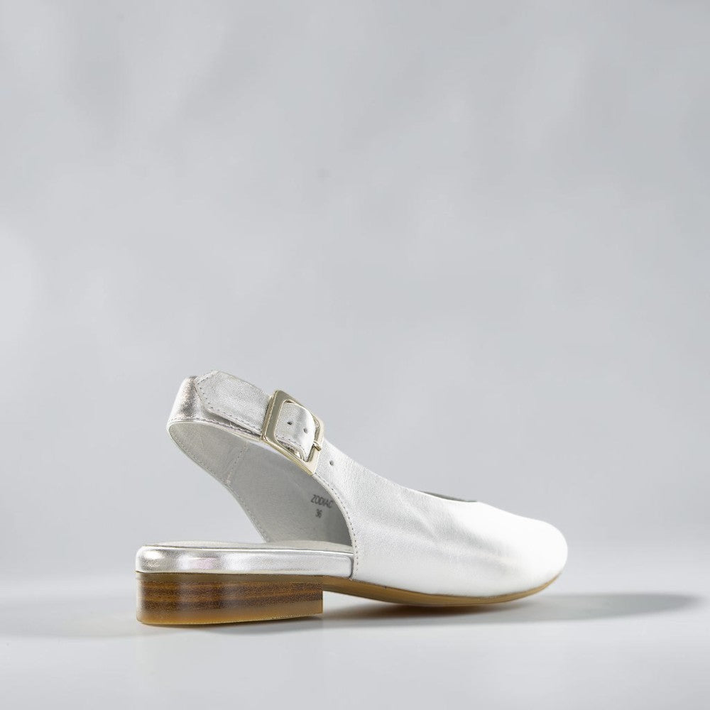 Silver Zodiac-themed sandals from NAKED ARCHES with intricate detailing and open-toe design.