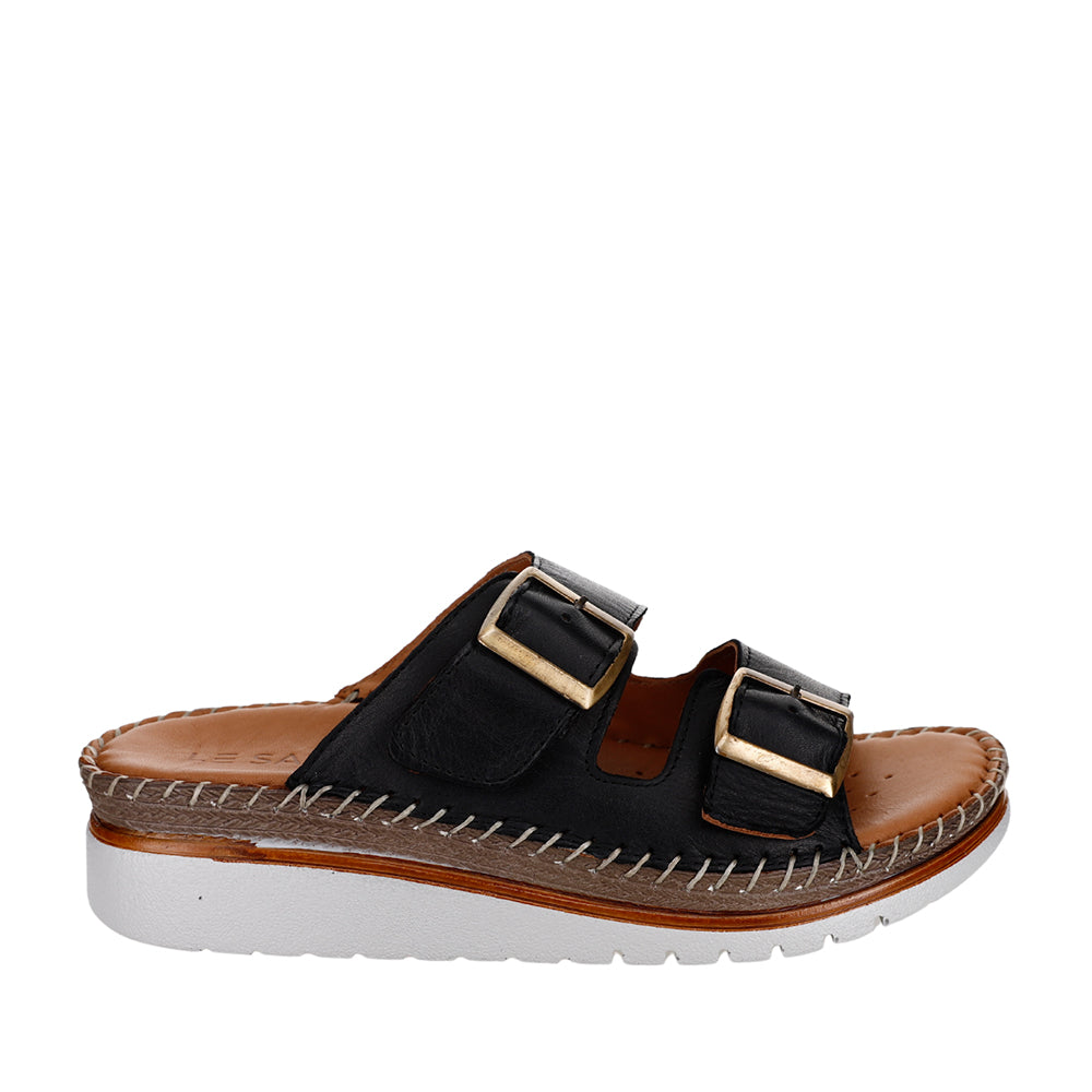 Le Sansa Freya black slip-ons with sleek design and comfortable fit, shown in a close-up image highlighting the stylish upper.