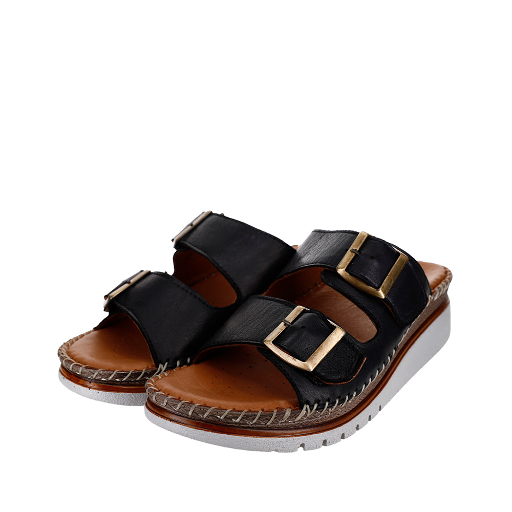 Black Le Sansa Freya slip-ons with sleek design and comfortable fit, shown on a plain background.