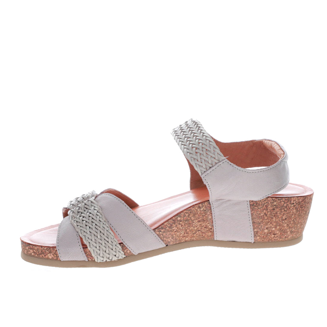 Le Sansa Alexa Stone sandals featuring beige straps and a flat sole, perfect for casual summer wear.
