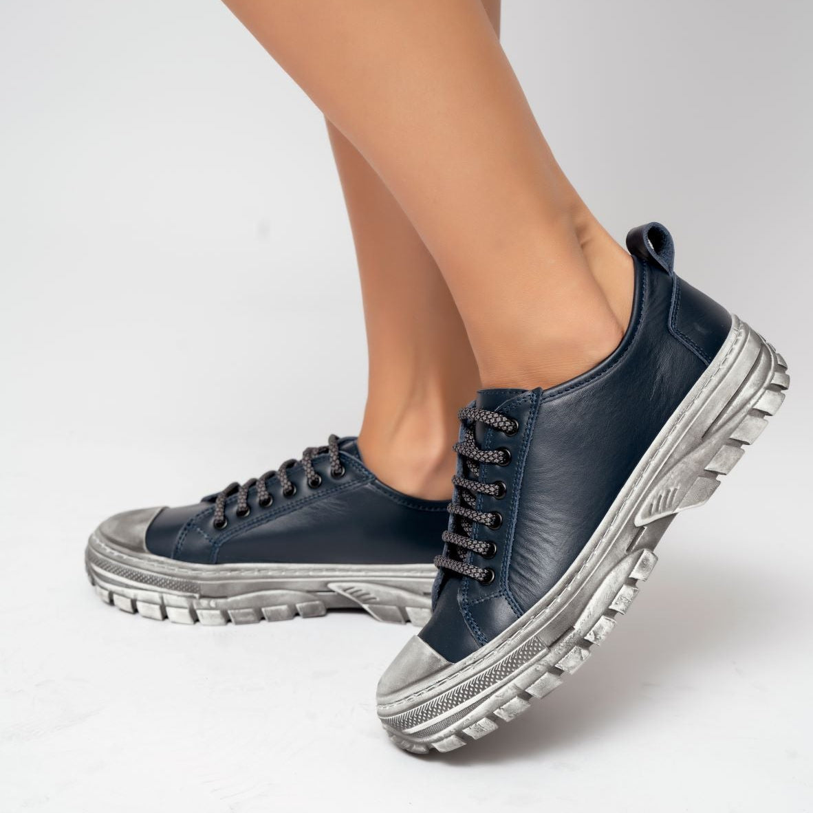 Le Sansa Rocky DK Navy sneakers featuring a sleek design with navy blue color and lace-up closure.