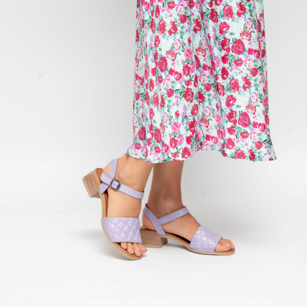 Le Sansa Lincoln Lilac sandals featuring open-toe design, strappy style, and comfortable flat soles.