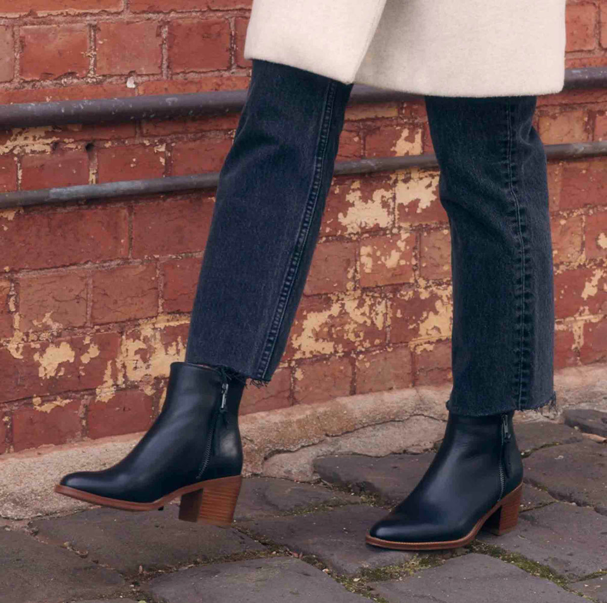 Black EOS Ciara boots with lace-up design and chunky heel, styled on a model showcasing their fashionable appearance.