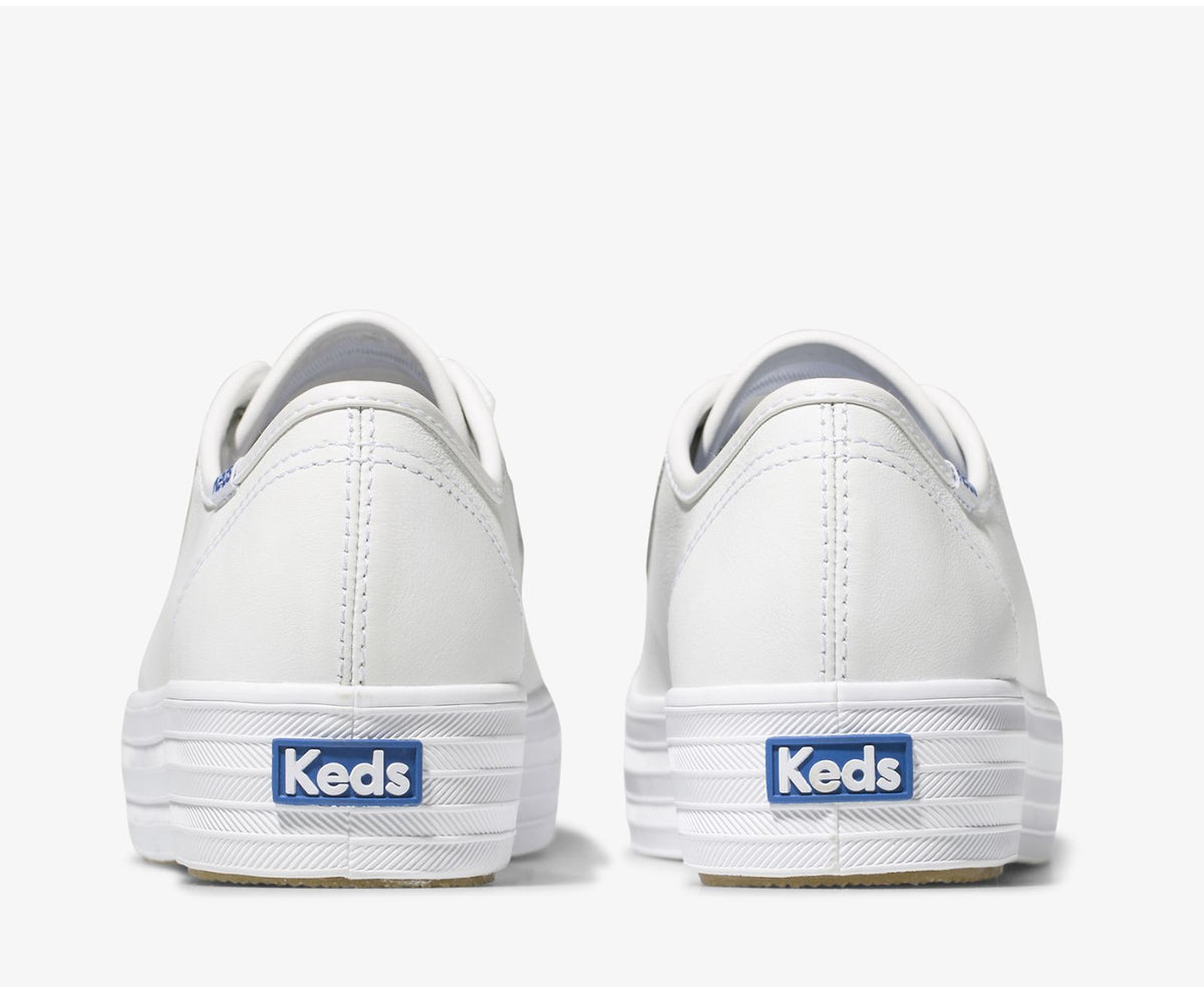 KEDS Triple Kick white sneakers featuring a classic low-top design with white canvas and rubber sole.