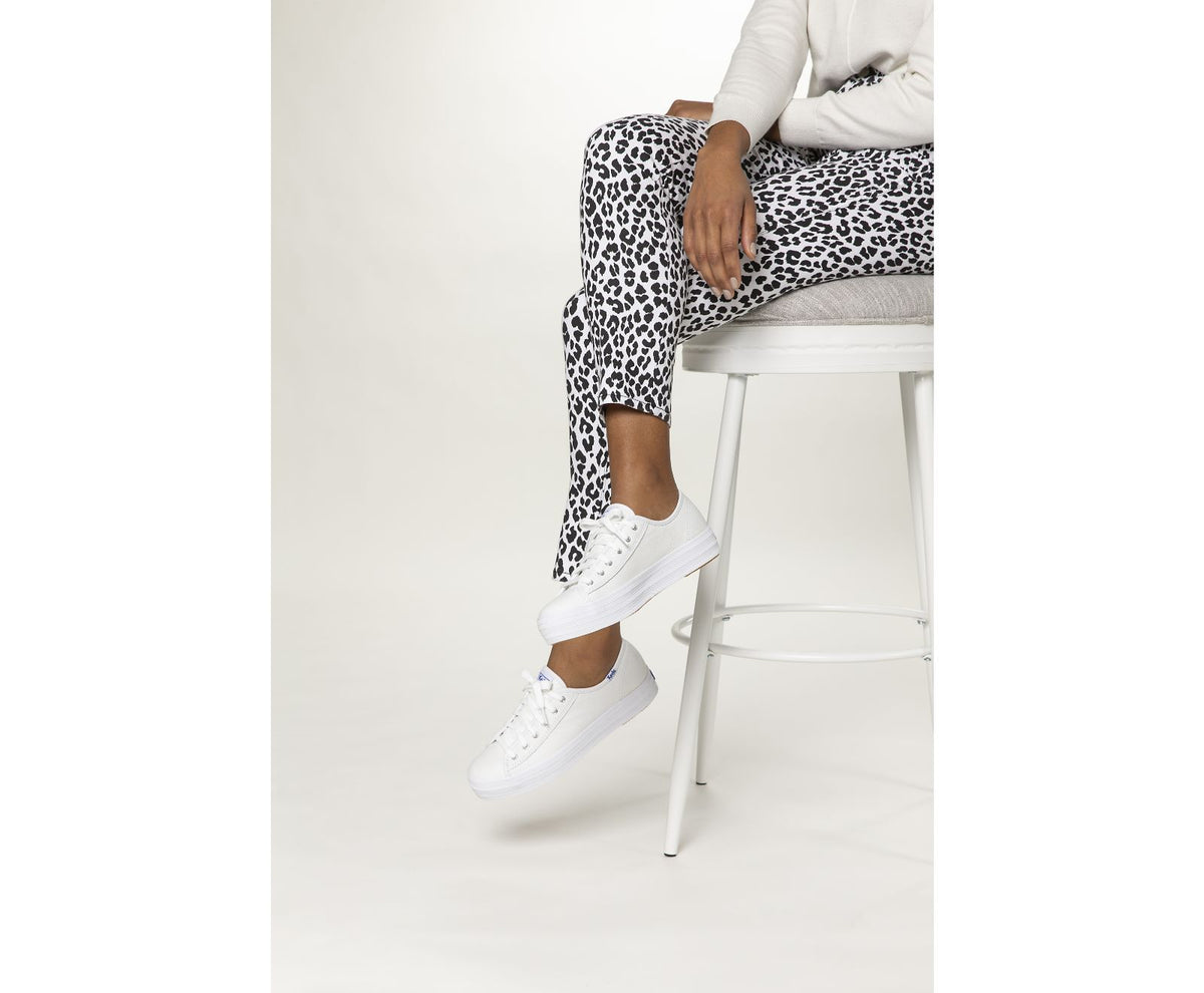 White KEDS Triple Kick sneakers with classic design, featuring white laces and rubber sole, displayed on a plain background.