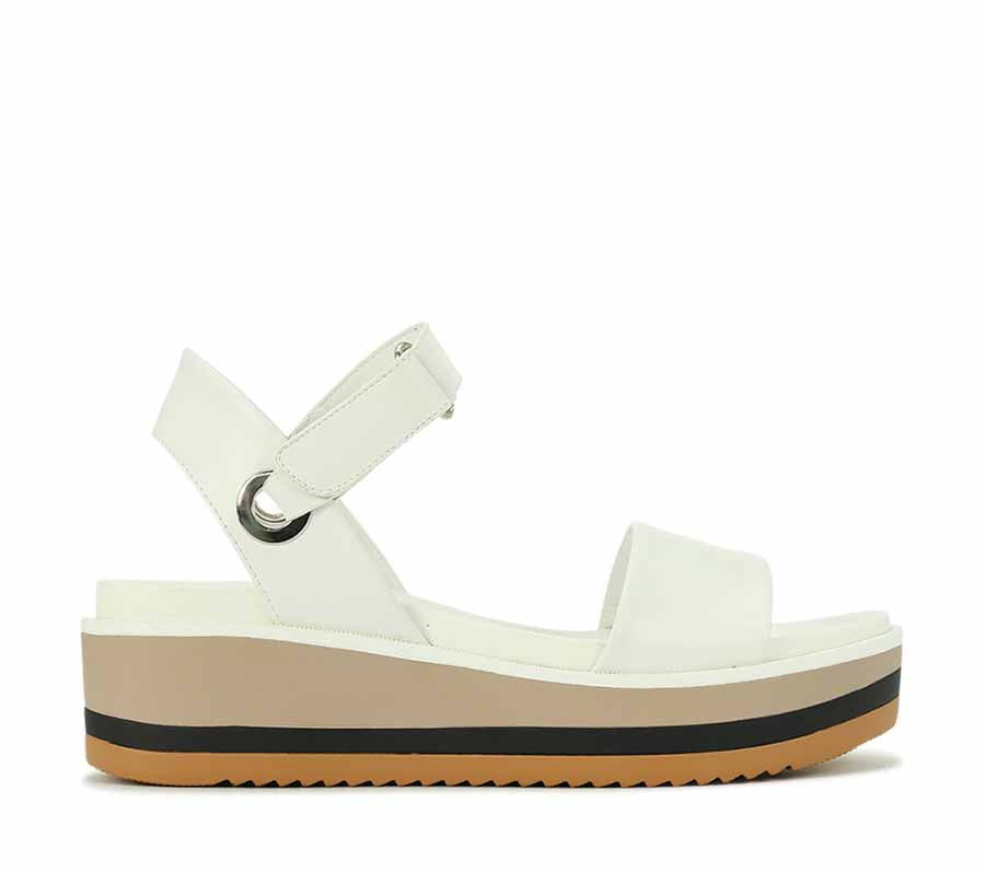 LOS CABOS Zita White sandals with open toe design, featuring sleek straps and a comfortable flat sole.