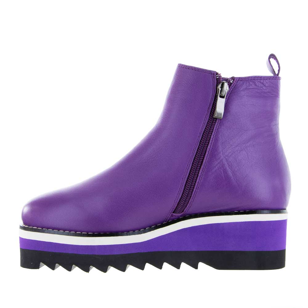 Le Sansa Trinity Violet boots featuring a stylish design with purple accents and a sleek leather finish.