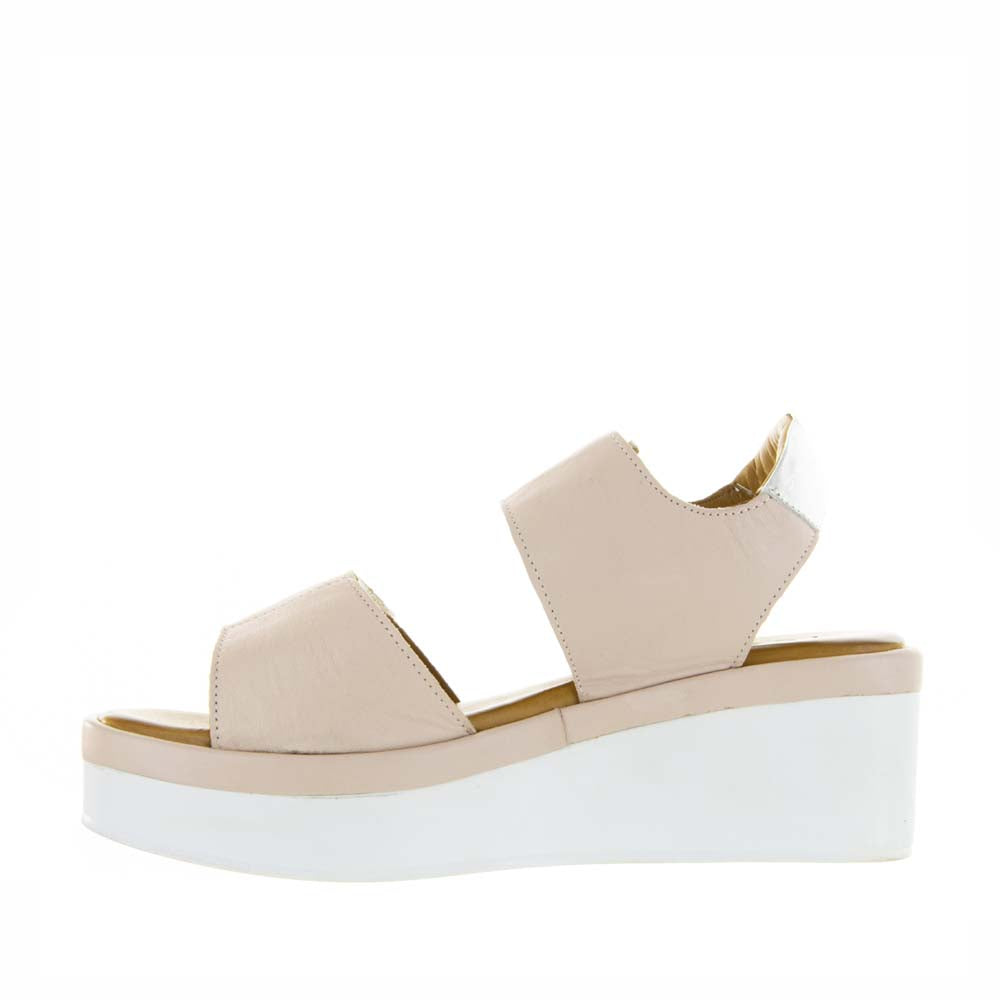 Le Sansa Tristen Cameo sandals featuring a strappy design and neutral tones, shown on a model's feet.
